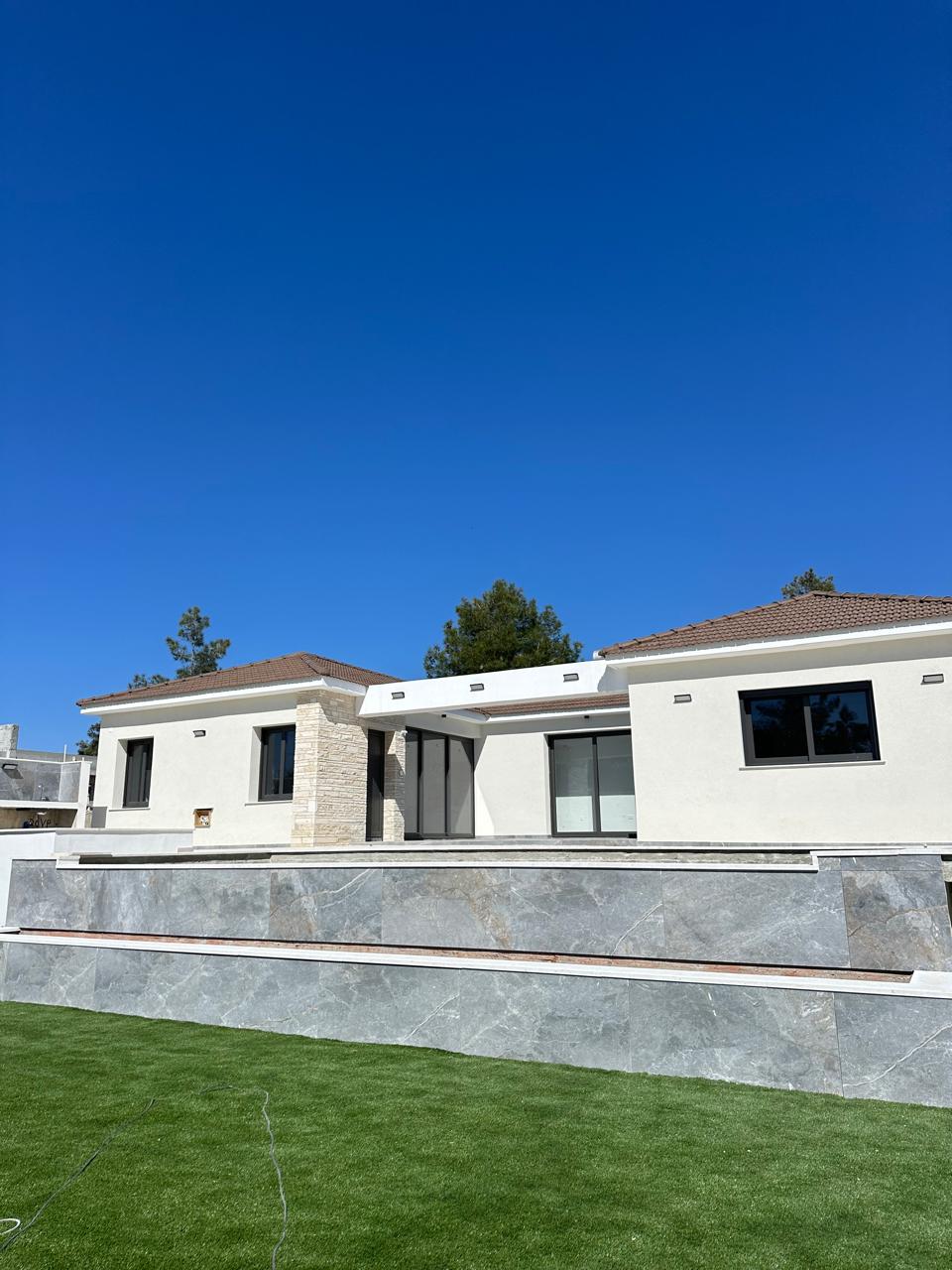 Contemporary L-shaped villa in Souni-Zanakia with marble terrace and landscaped lawn
