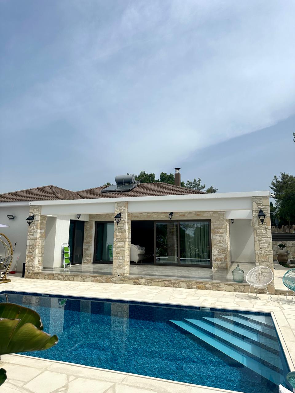 Stone-clad bungalow in Souni-Zanakia with covered veranda and mosaic swimming pool